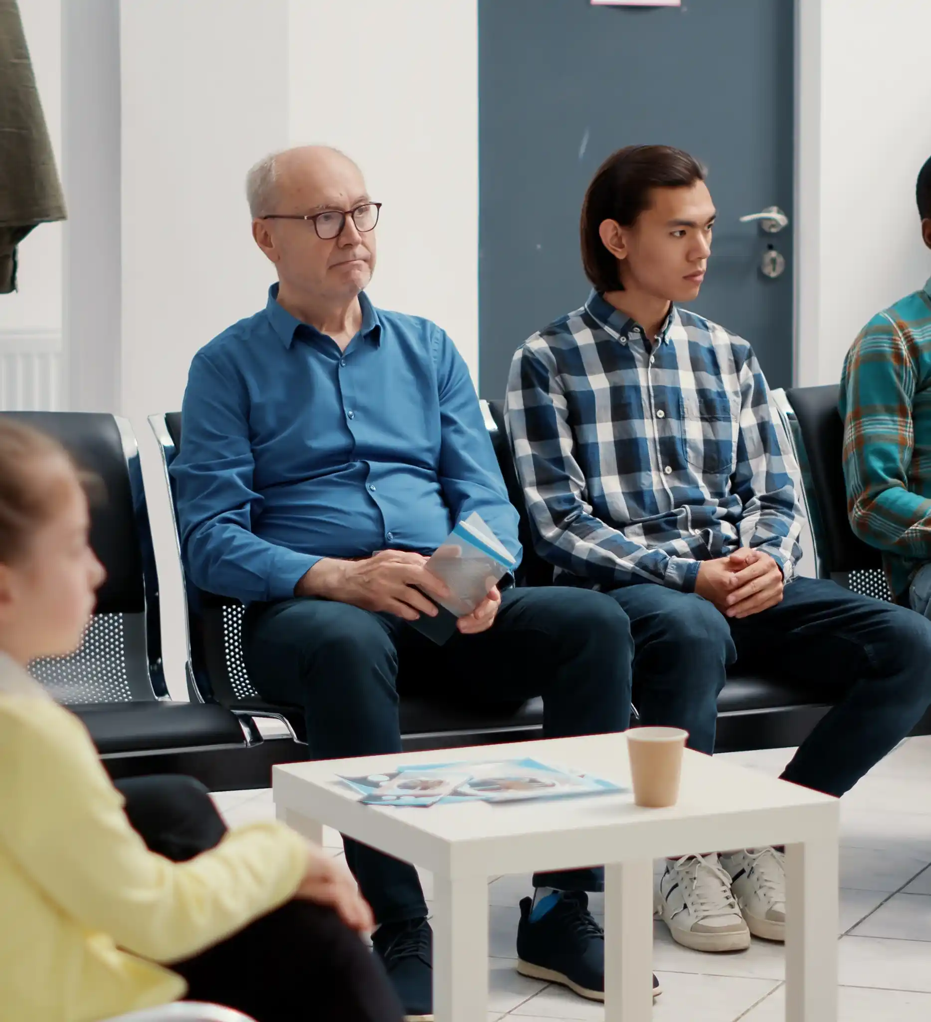 Patients seated in a hospital waiting area ahead of their consultations