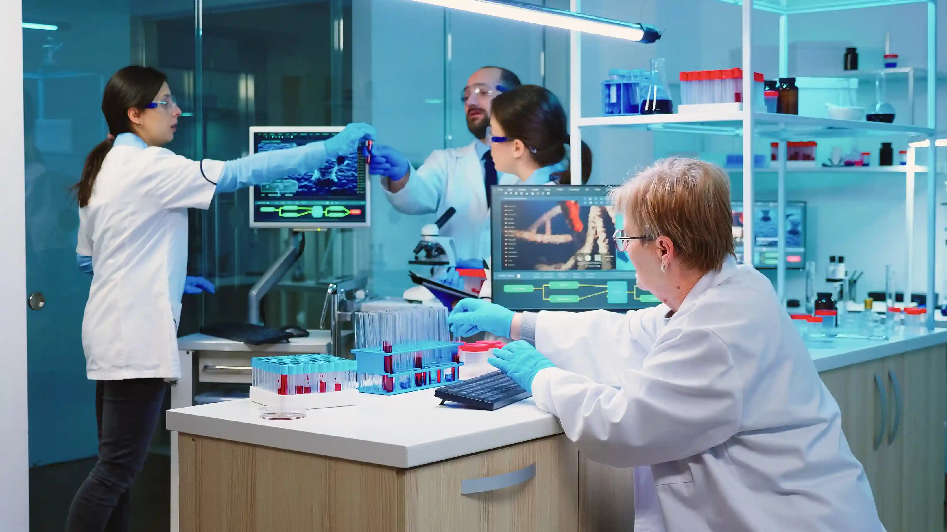 Lab technician scanning a barcoded sample tube into laboratory management software