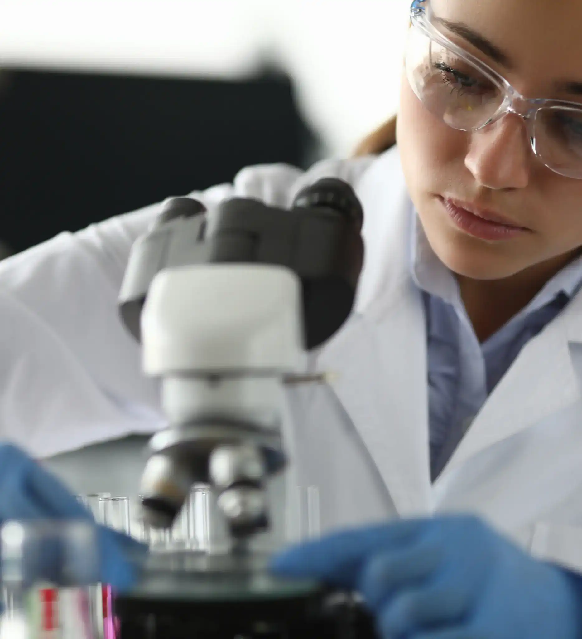 a female lab technician working with a microscope